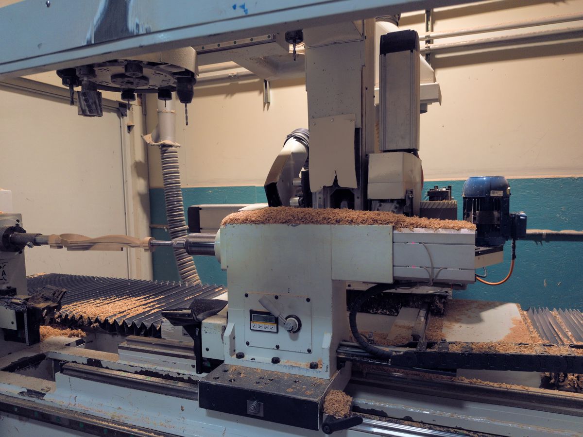 A lathe in the workshop, with a turned blank still mounted.