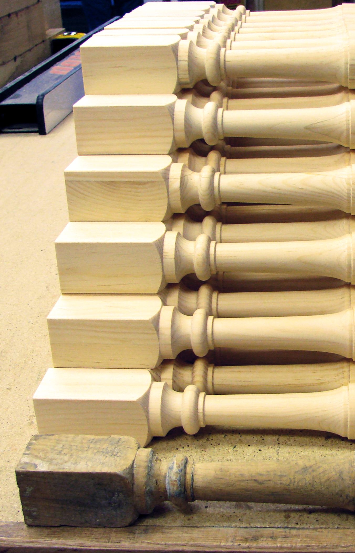 Turned wooden spindles photographed from the side.